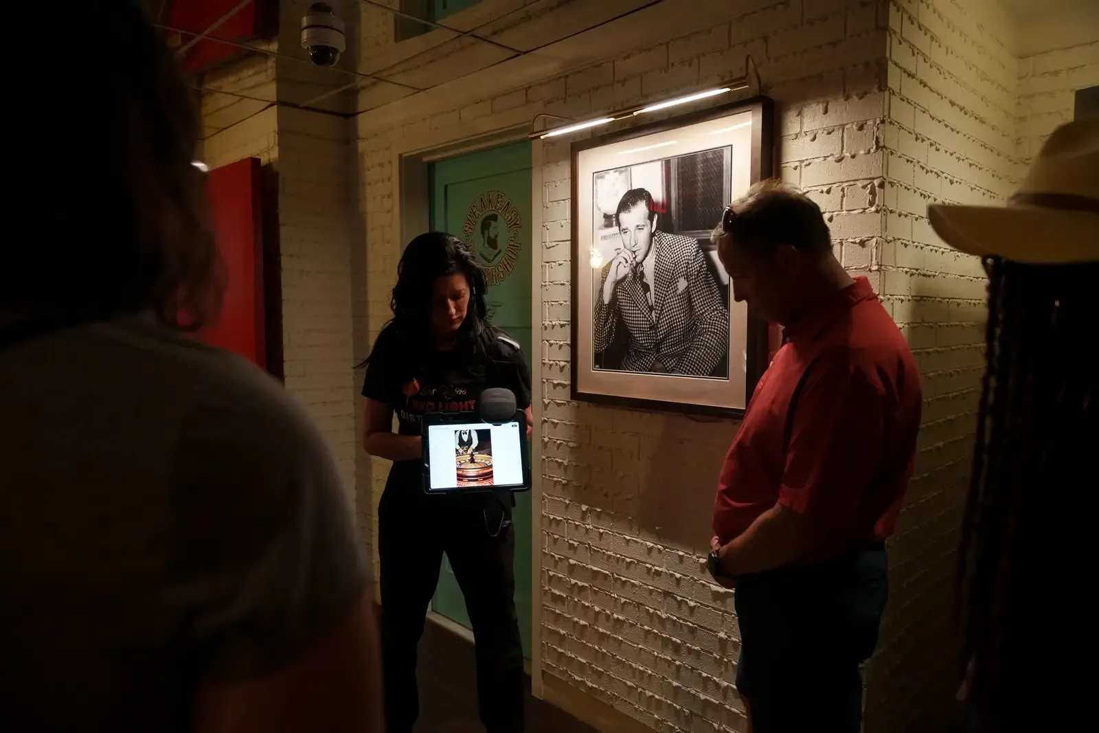 A Las Vegas Guided Tours guide showing archival photos to guests in downtown Las Vegas